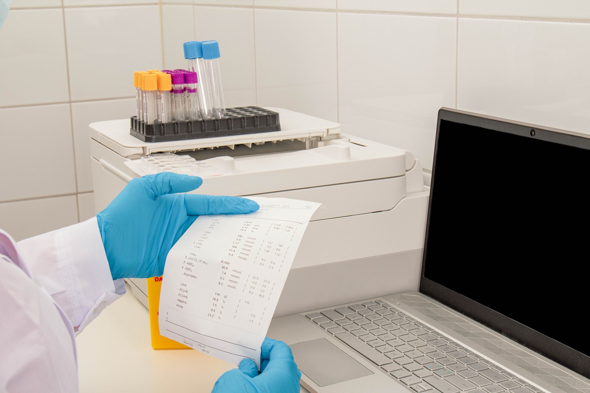 A medical laboratory scientist reviewing blood test results